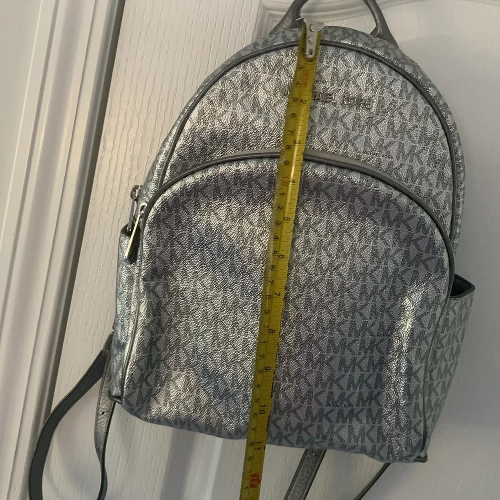 Michael Kors Silver shimmer Monogram Backpack shiny zipper leather compartments‎